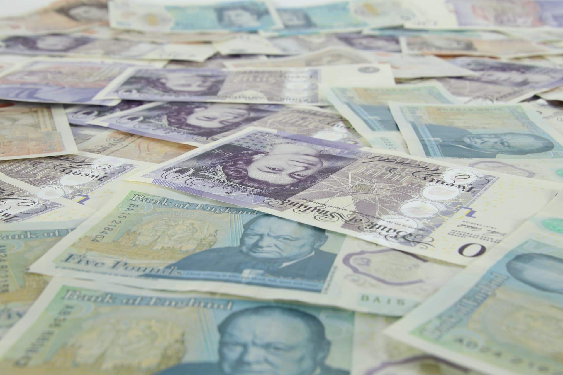 Table Covered in British Notes of Money