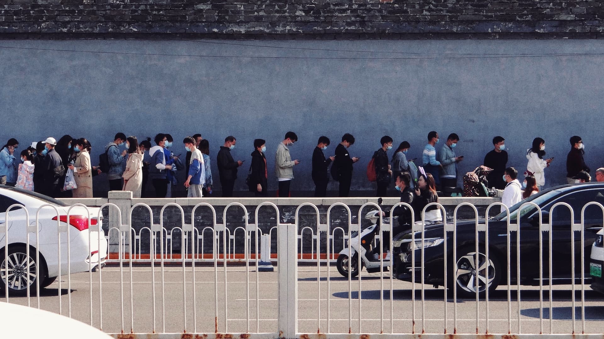 Queue of people lining up outside of store